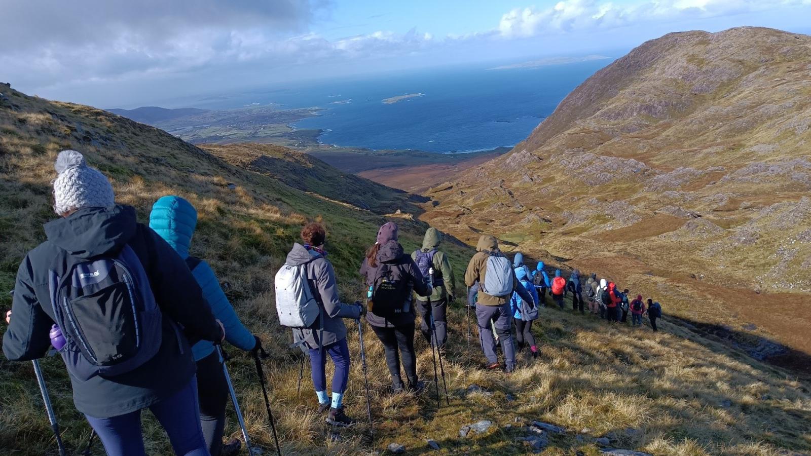 tirlán employees walking mountain